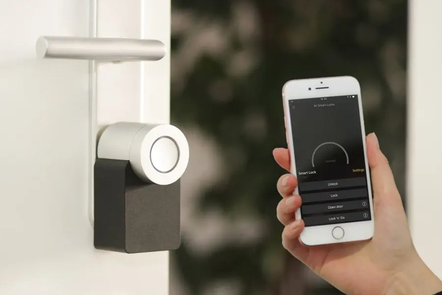 A smart lock being unlocked from a phone at a front door