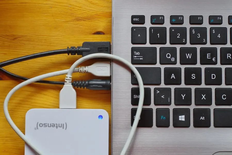 An external drive plugged into a laptop