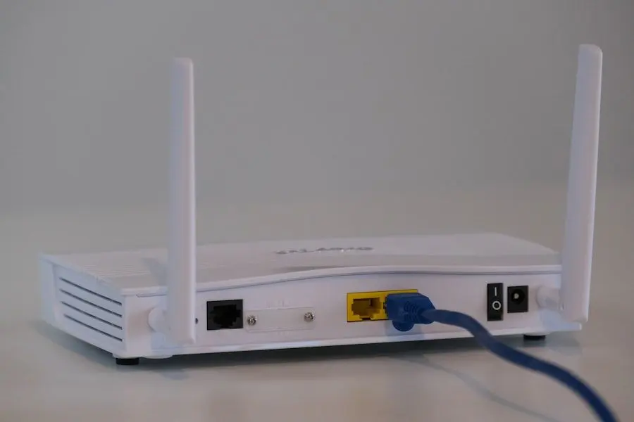 A WiFi router with its network cable plugged in